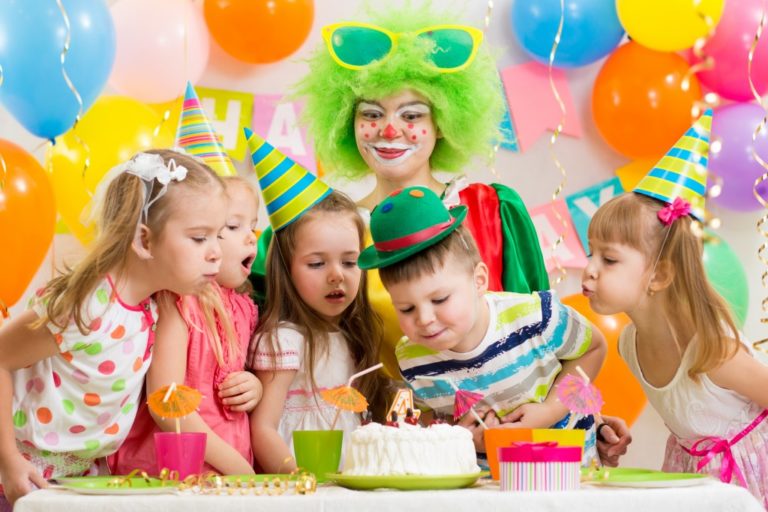 Kids blowing a birthday candle