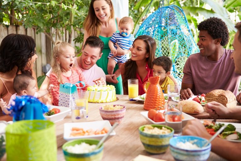 Family celebrating a birthday outdoors