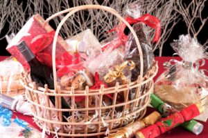 Christmas hamper basket with a chocolate Santa, cookies and a bottle of wine