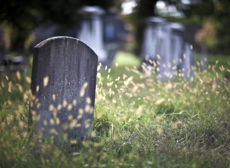 Tombstone and graves in an ancient church graveyard