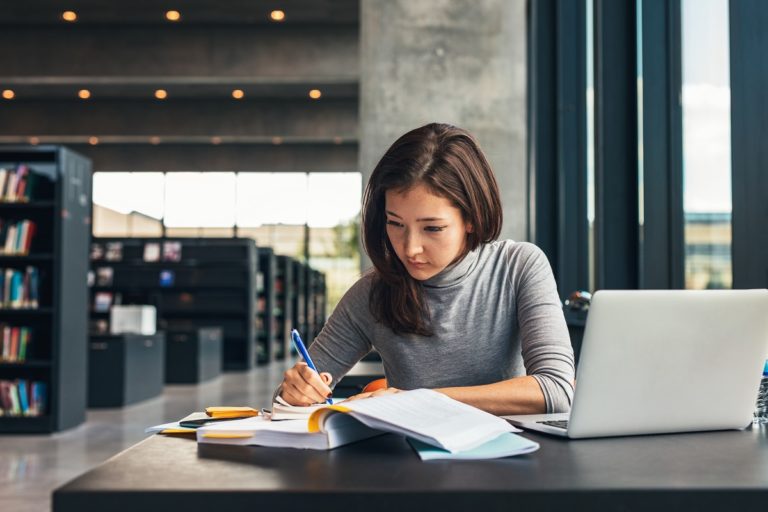 Student reviewing in the library