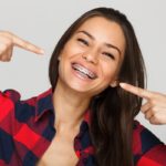 Woman pointing at her braces