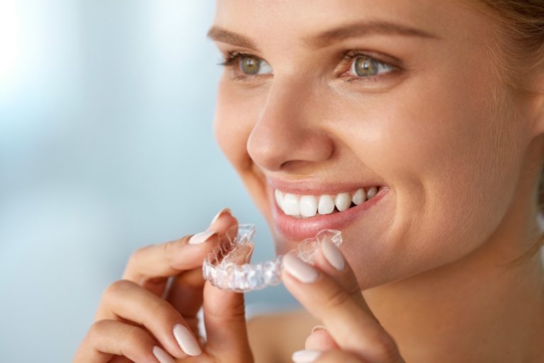 Woman about to wear her invisible aligners