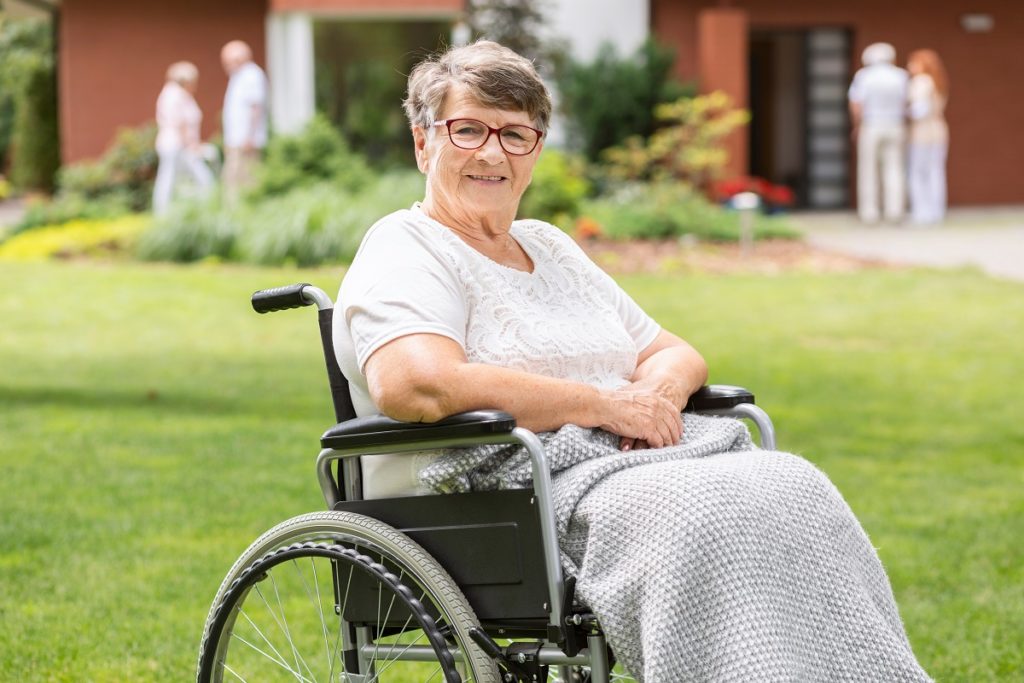 smiling old woman on a wheelchair