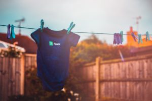 old baby clothes hanging outside to dry