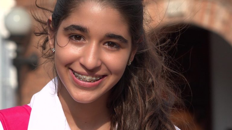 Young woman smiling with braces