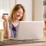 woman excited about online shopping with her laptop and credit card