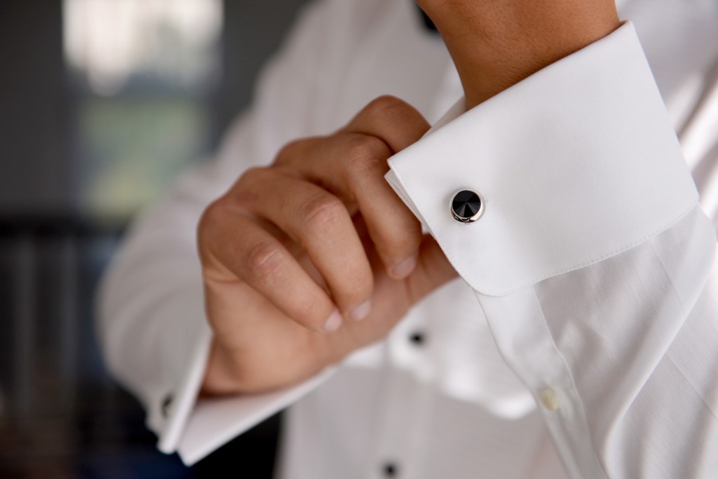 fixing white shirt with cufflinks