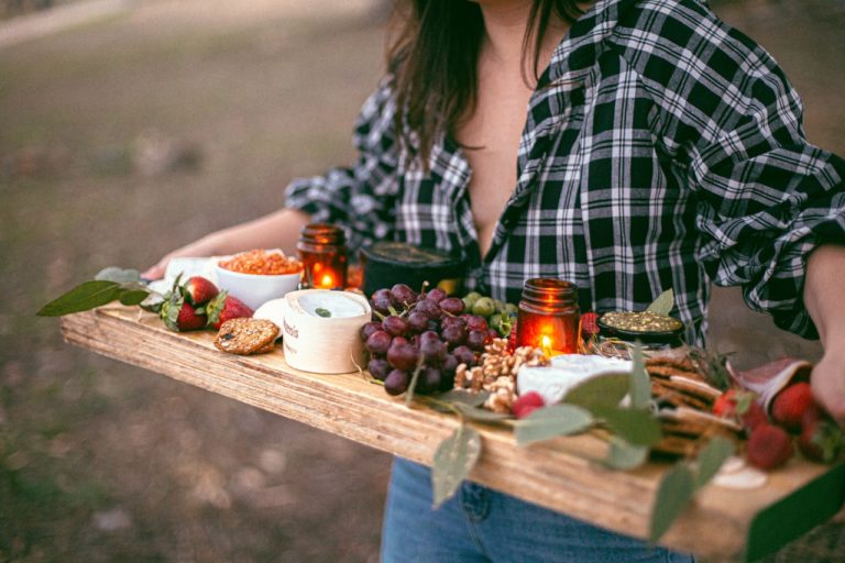 woman holding a charcuterie board