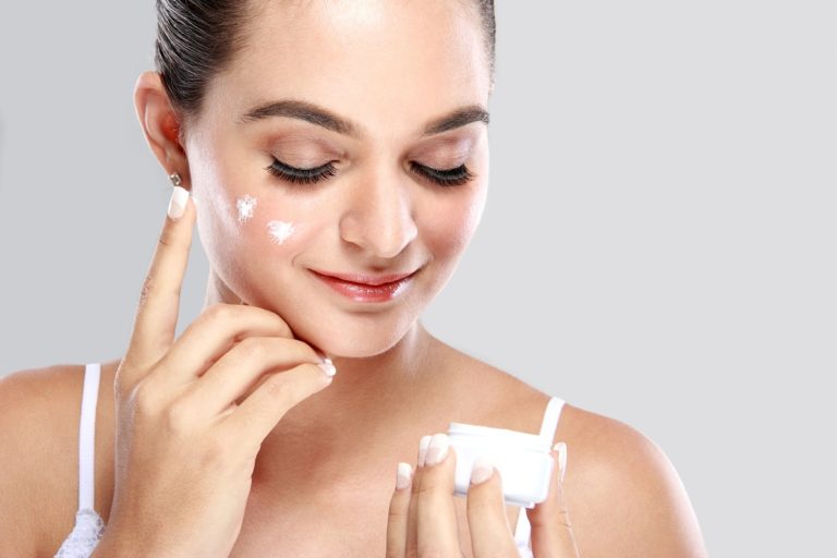 woman applying moisturiser