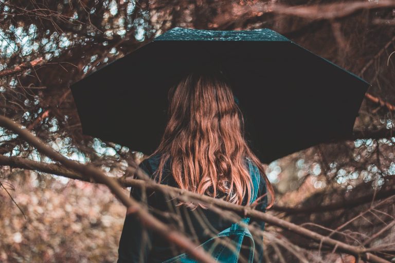 long haired woman with umbrella in the rain