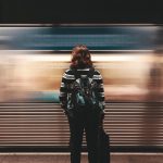woman-standing-moving-train
