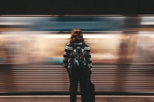 woman-standing-moving-train