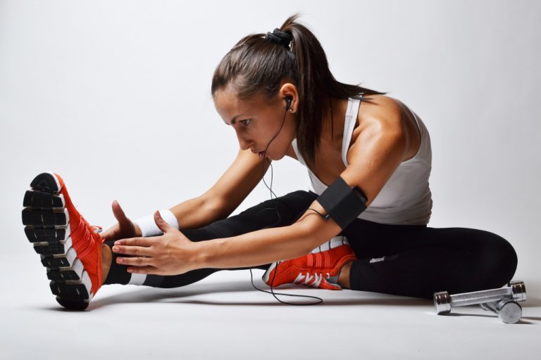 Woman stretching her legs on the ground