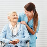 senior in a wheelchair with caregiver