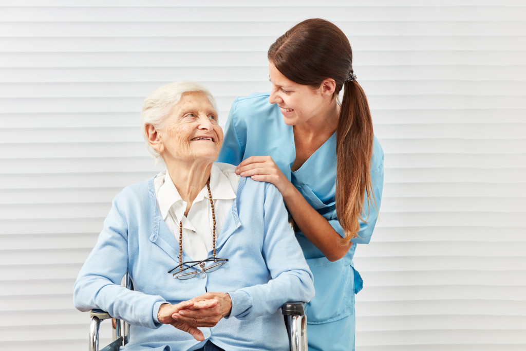 senior in a wheelchair with caregiver