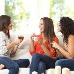 Women talking while drinking tea in a cozy living room