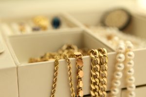 Gold and pearl necklaces inside a jewelry box.