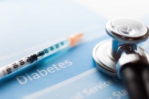 stethoscope and syringe on diabetes test
