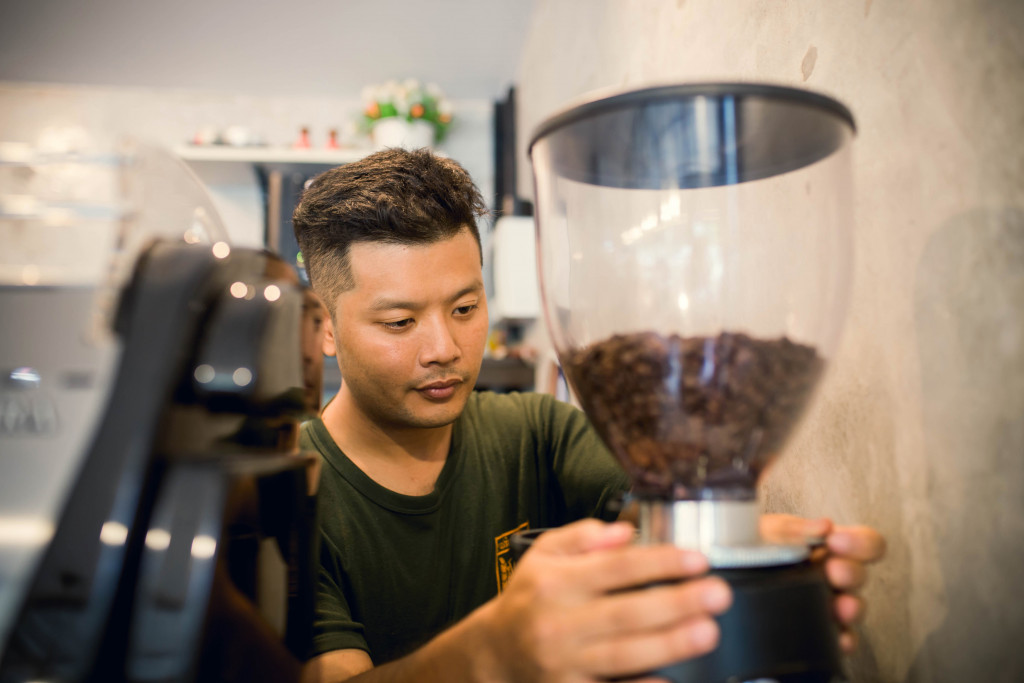 A man using a coffee grinder