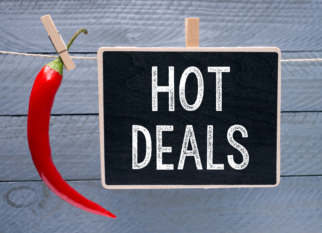 HOT DEALS words on chalkboard with a red hot chili beside it